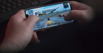 hands holding a phone horizontally playing a mobile game