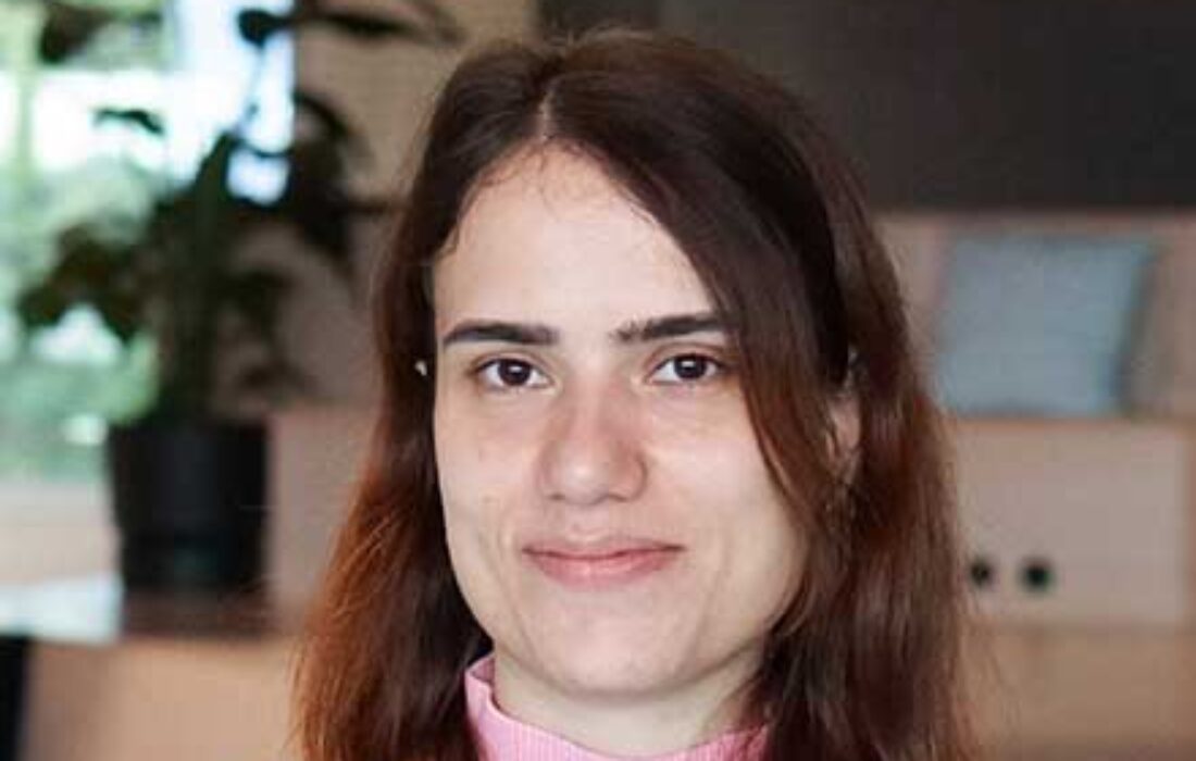 young brunette woman looking at the camera smiling slightly