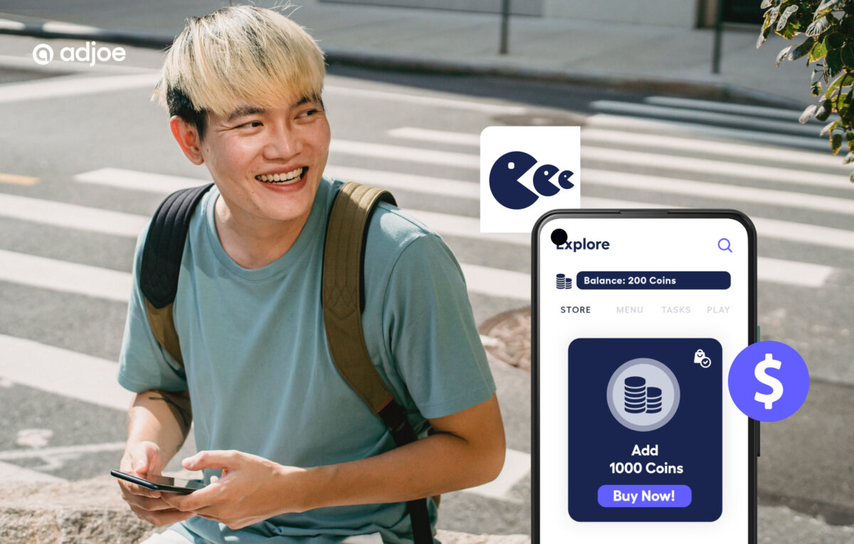 young man smiling to the side outdoors holding his phone with decorative icons to represent in app purchases