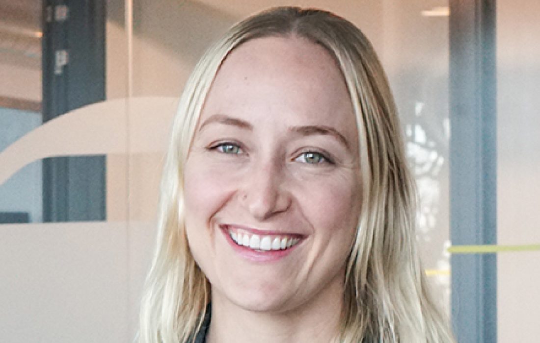 young blond woman smiling at camera