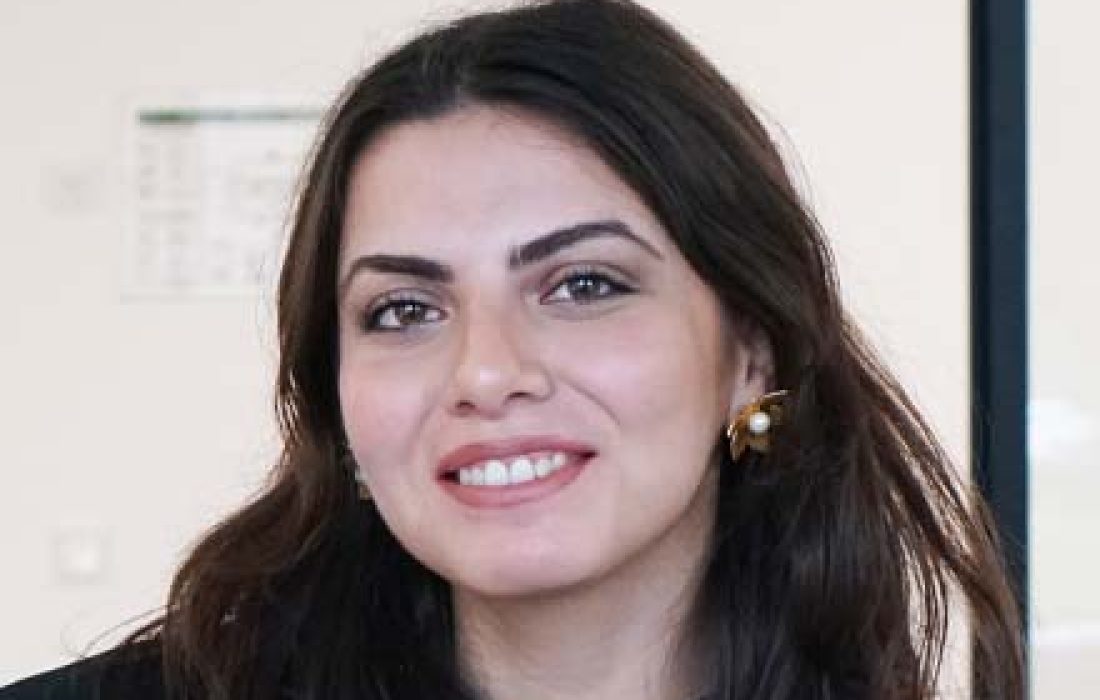 picture of young brunette woman smiling at camera