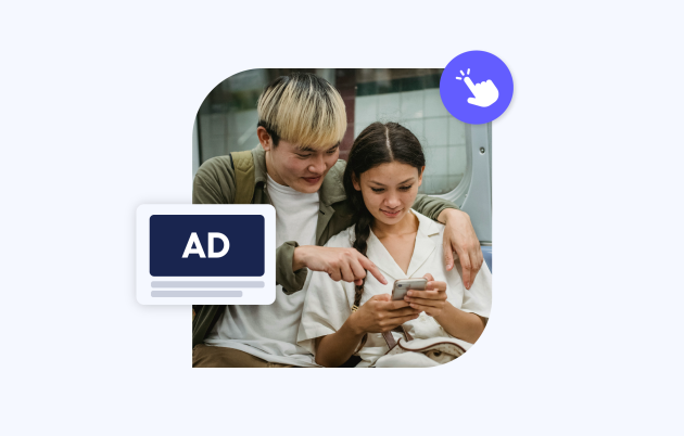 two young people looking over a phone