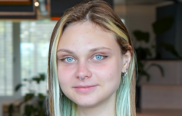 image of young blond woman smiling subtly into camera