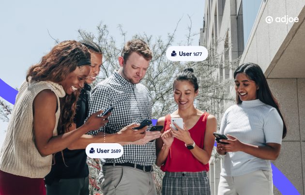 a group on people outside looking down at their phones