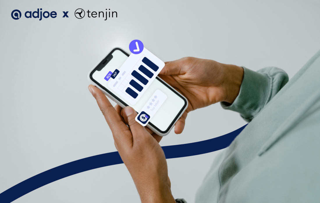 close-up of hands holding phone with bar chart and tenjin logo