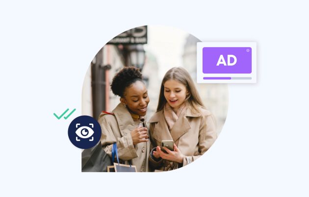 two young women looking down at a phone