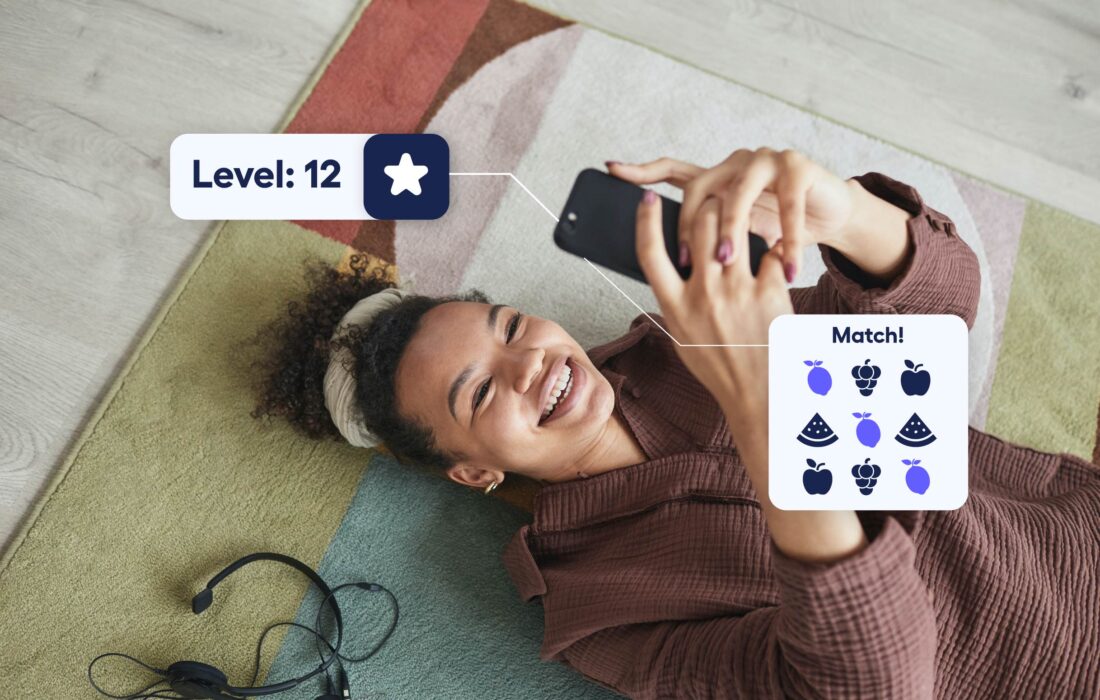 young woman looking up at her phone smiling