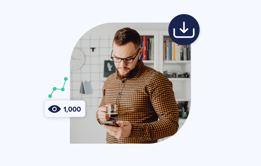 young man inside looking down at his phone