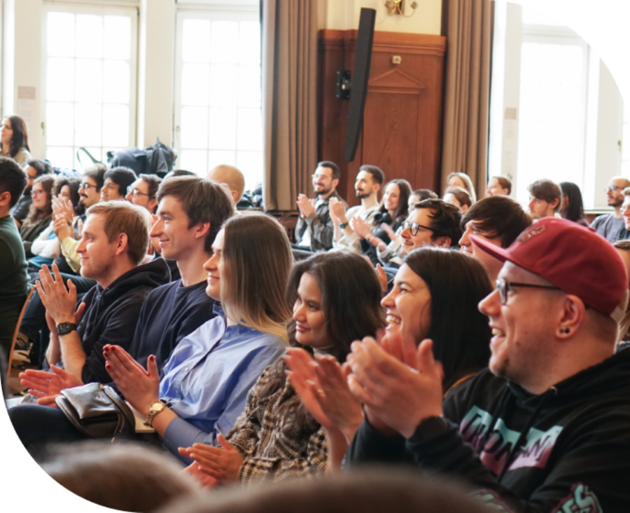 room full of people clapping their hands