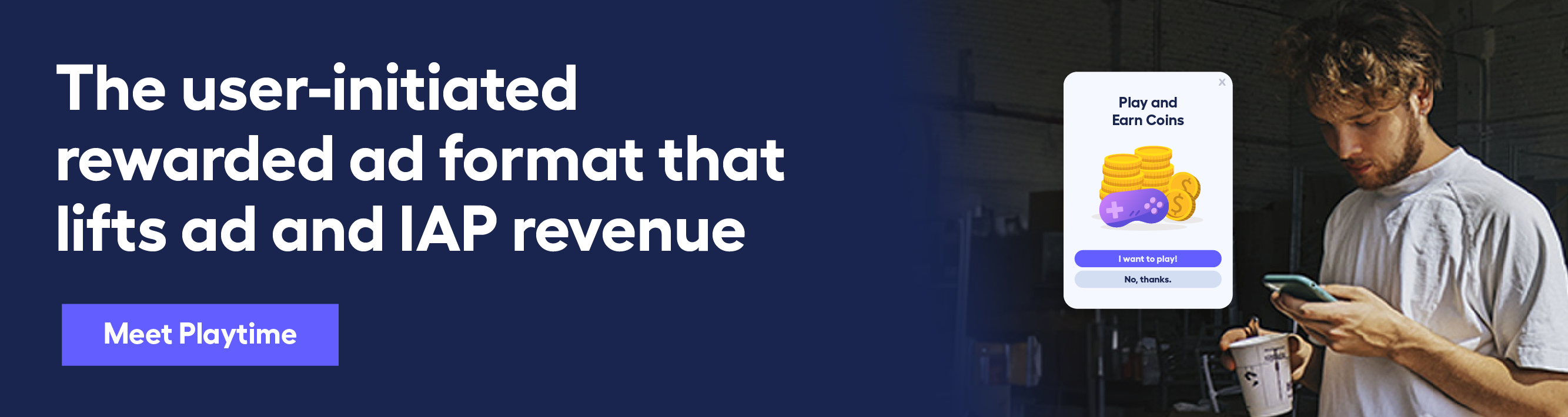 young man looking down at his phone with decorative screen element telling him to Play and earn coins. 