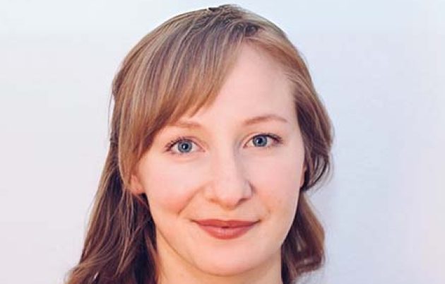 young woman smiling into camera