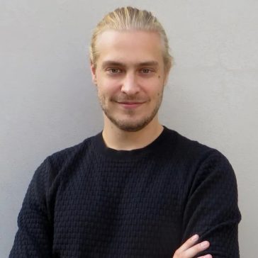 young blond man smiling at the camera