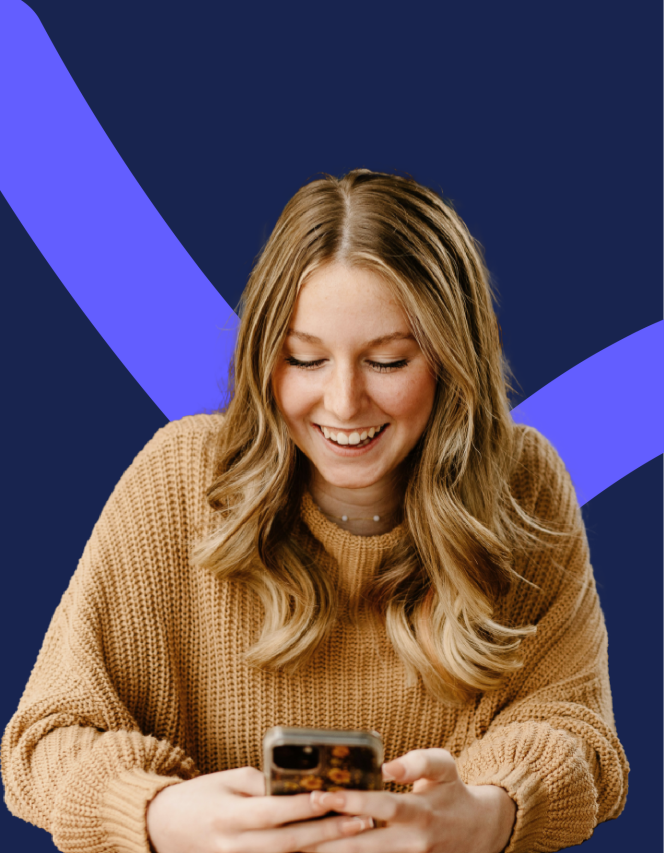 young blond woman looking down and smiling at her phone