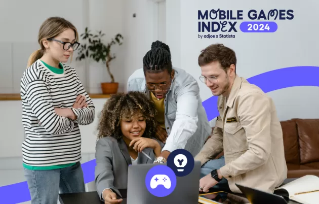 group of young people leaning over a laptop with decorative gaming elements