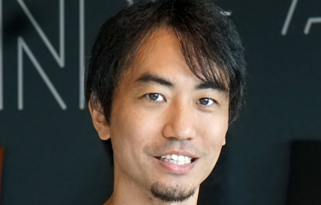 image of young dark-haired man smiling into camera