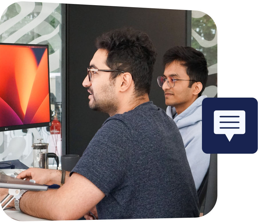 two young developers sat infront of a screen