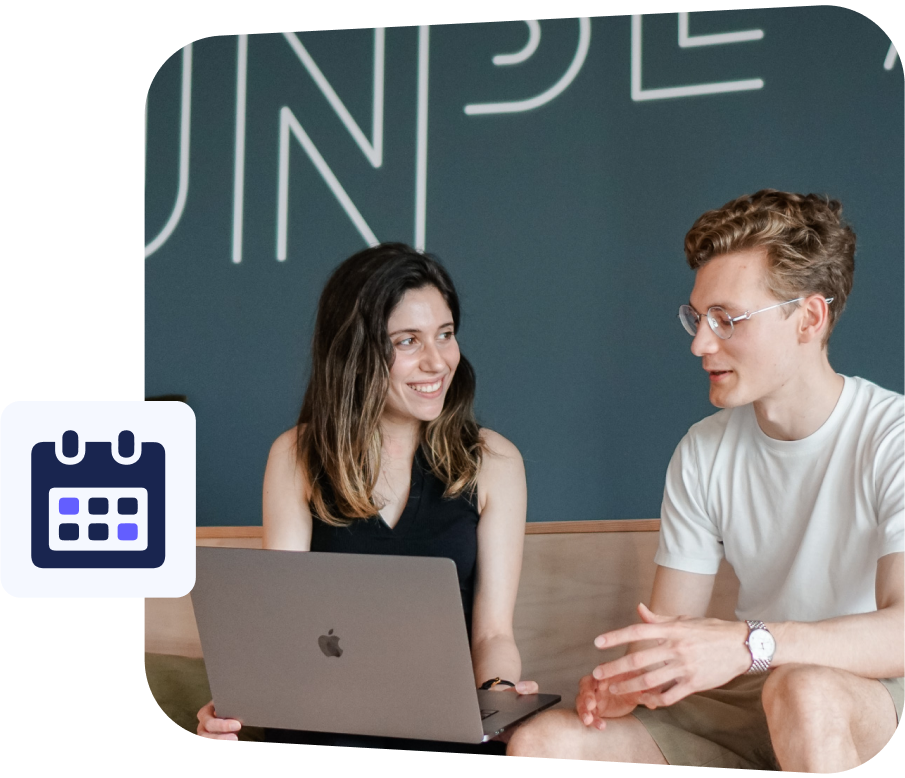 two young employees discussing work at a laptop